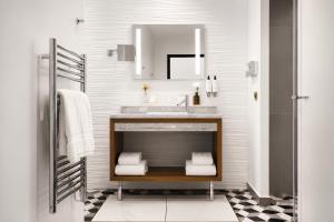a bathroom with a sink and a mirror at Hôtel Mayflower Opera in Paris +57 photos