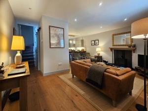 a living room with a couch and a fireplace at Balnain Street Cottage in Inverness
