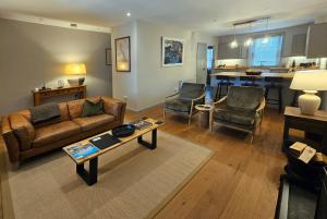 a living room with a couch and a table at Balnain Street Cottage in Inverness