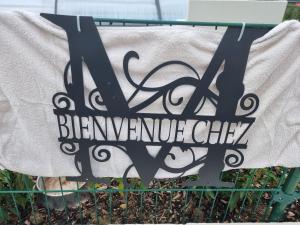 a sign on a fence with a sign that reads bennettotide clubvy at Comfortable studio in Bevaix with mountain view - 30 m² + Spa in Bevaix