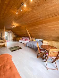a bedroom with a bed and a table and chairs at Maison chaleureuse à Mont >Vue montagne & cheminée in Mont +10 photos
