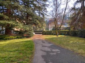 a path in a park with trees and a house at Appartement charmant à Chambéry de 35 m² + balcon privatif in Chambéry +8 photos