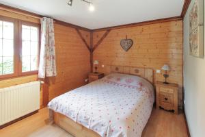 a bedroom with a bed in a room with wooden walls at Chalet charmant à Stosswihr avec vue sur montagne + balcon in Stosswihr