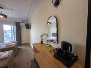 a living room with a large mirror and a couch at Celeste Blu Suites & Rooms in Paralia Katerinis +133 photos
