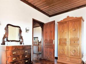 a bathroom with a wooden dresser and a mirror at Spacious house with sea view in Volos in Volos
