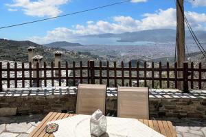 a table and chairs with a view of a city at Spacious house with sea view in Volos in Volos
