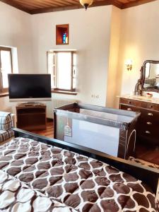a large bed in a room with a flat screen tv at Spacious house with sea view in Volos in Volos +48 photos