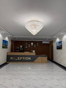 a lobby with a large chandelier in a hotel at Al-Amin in Termiz