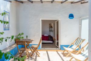 a room with a table and chairs and a bedroom at Albufeira Oasis Pool & Views in Albufeira