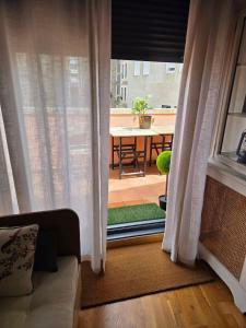 a living room with a view of a patio with a window at VilaVigo apartamento in Vigo