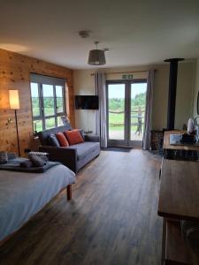 a living room with a bed and a couch at Cabin View in Cuminestown