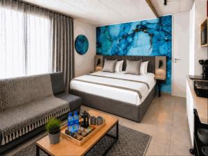 a hotel room with a bed and a couch at Burleigh Ballito in Ballito
