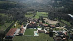 an aerial view of a village with houses and trees at Pazo de San Pedro de Bembibre in Taboada