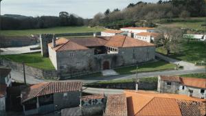 an aerial view of an old castle with buildings at Pazo de San Pedro de Bembibre in Taboada +11 photos