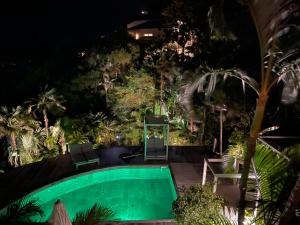 a swimming pool in a garden at night at Heavenly Villa in Gustavia with Private Pool in Gustavia