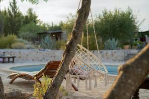 a swing in front of a swimming pool at Spacious House with Private Pool in Stari Grad in Stari Grad