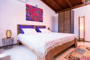 a bedroom with a bed and a painting on the wall at Spacious House with Private Pool in Stari Grad in Stari Grad