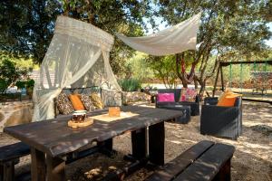 a picnic table with a canopy and chairs under trees at Spacious House with Private Pool in Stari Grad in Stari Grad