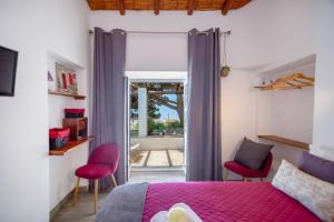 a bedroom with a bed and two red chairs at Albufeira Oasis Pool & Views in Albufeira +93 photos