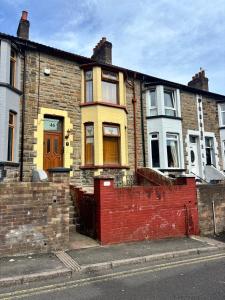 an old brick house on the side of a street at Maple, 3 Double Beds, Contractors Welcome in Abertillery