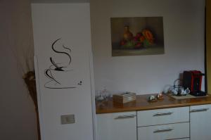 a kitchen with a counter and a picture of fruit at Cozy apartment in Caltagirone - 70 m² with balcony in Caltagirone +33 photos