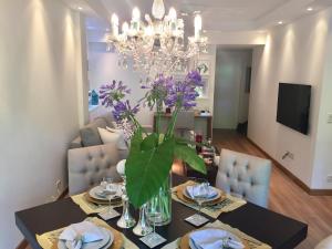 a dining room with a table and a chandelier at Luxury Apartment Tagle with flexible Chek in or Check out in Buenos Aires