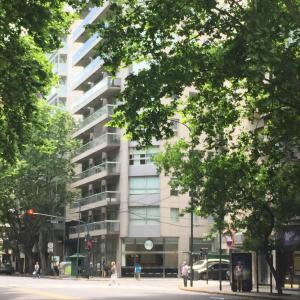 a tall white building with people walking in front of it at Luxury Apartment Tagle with flexible Chek in or Check out in Buenos Aires