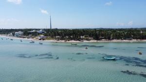 an aerial view of a beach with boats in the water at Meeraa Residency in Rāmeswaram