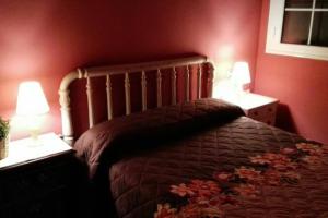 a bedroom with a bed with two lamps on it at Charming Apartment in Castelserás - 60 sqm - Parking included in Castelserás