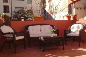 three wicker chairs and a table on a patio at Charming Apartment in Castelserás - 60 sqm - Parking included in Castelserás