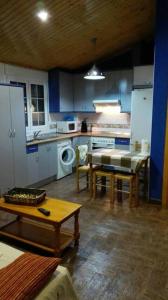 a kitchen with blue cabinets and a table in it at Charming Apartment in Castelserás - 60 sqm - Parking included in Castelserás