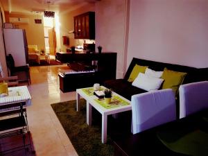 a living room with a couch and a table at Two Bedroom Shmeisani Apartment in Amman