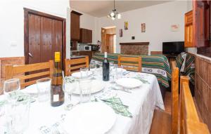 a dining room with a table with a bottle of wine at Charming House in Montefrío with Private Pool in Montefrío