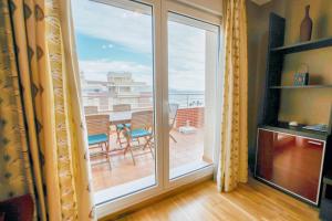 a room with a balcony with a sliding glass door at Modern apartment in Roquetas de Mar with sea view in Roquetas de Mar