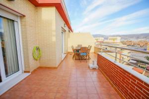 a balcony with a table and chairs on it at Modern apartment in Roquetas de Mar with sea view in Roquetas de Mar +56 photos