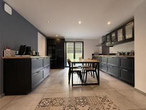 a kitchen with a table and chairs in it at Iduzki-alde bat in Souraïde