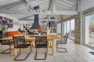 a dining room with a large wooden table and chairs at Villa spacieuse à Bidart avec piscine privée 330 m² in Bidart +42 photos