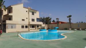 a large swimming pool in front of a building at Casa del Jable in Parque Holandes
