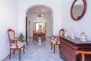 a living room with a dresser and a dining room at House by the sea in Can Picafort with terrace in Can Picafort