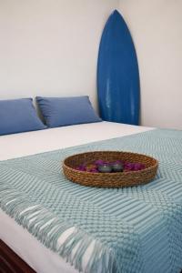 a basket of flowers sitting on a bed at Zen Yoga & Surf House in Arugam Bay