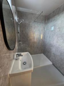 a bathroom with a sink and a mirror at Cabin View in Cuminestown +17 photos