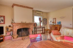 a living room with a fireplace and a couch at Maison au charme champêtre - Monlaur-Bernet in Monlaur-Bernet