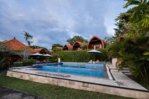 a swimming pool in the yard of a house at Druwa Bali in Uluwatu
