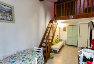 a room with a bunk bed and a staircase at Maison conviviale à Argelès-sur-Mer avec piscine partagee 35 m² in Argelès-sur-Mer