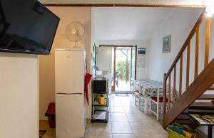 a living room with a refrigerator and a tv at Maison conviviale à Argelès-sur-Mer avec piscine partagee 35 m² in Argelès-sur-Mer