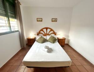 a bedroom with a large bed with two night stands at Cisne del Mar ComoTuCasa in Castellón de la Plana