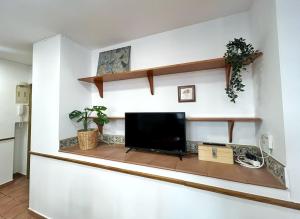 a living room with a flat screen tv on a wall at Cisne del Mar ComoTuCasa in Castellón de la Plana