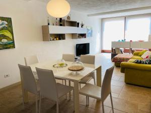 a dining room and living room with a table and chairs at Charming Apartment in Nardò with Shared Pool in Nardò