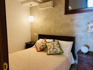 a bedroom with a bed with two pillows on it at Charming Apartment in Nardò with Shared Pool in Nardò +35 photos