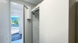 an empty refrigerator in a room with a window at Tahko North Lodge B 5 in Kuopio